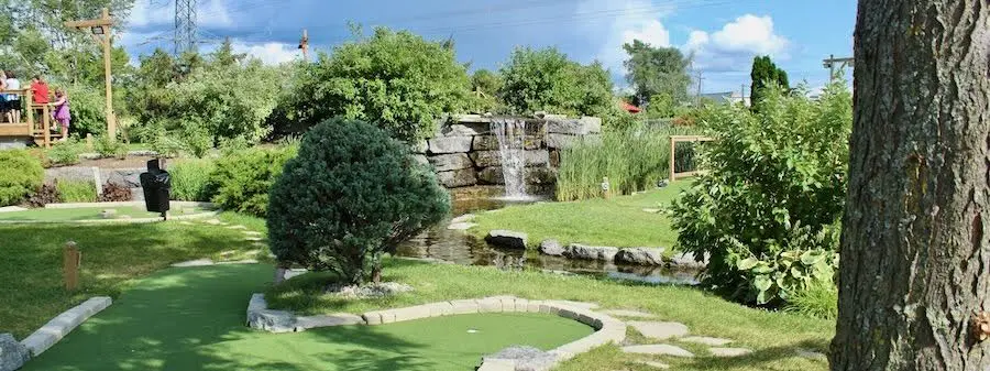 Patio and pond at Mini Golf Gardens at night