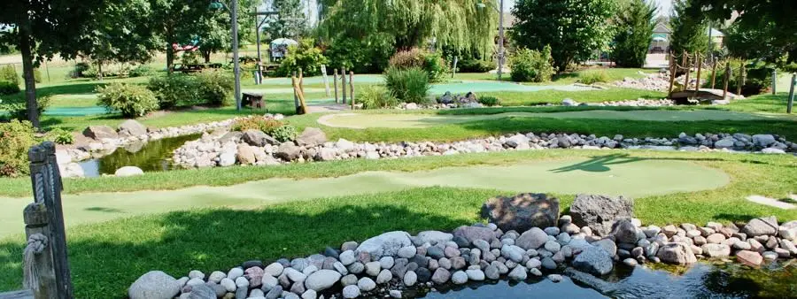 Mini golf green beside pond